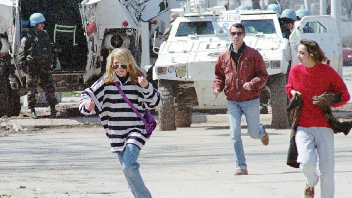 Civiles corren en la conocida como avenida de los francotiradores de Sarajevo, protegidos por un tanque de la ONU, en abril de 1995.