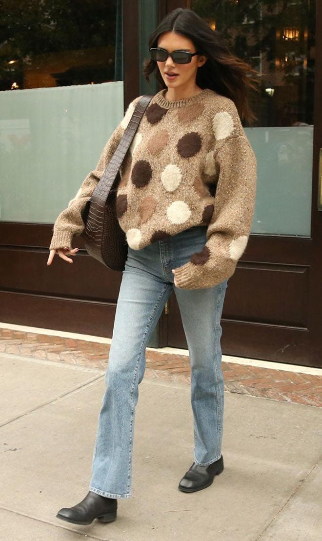 Kendall Jenner con jersey de lunares, vaqueros y bolso marrón