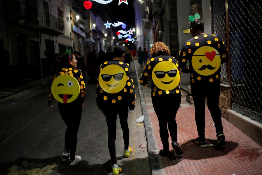 Revellers dressed up as emoticons take part in ...