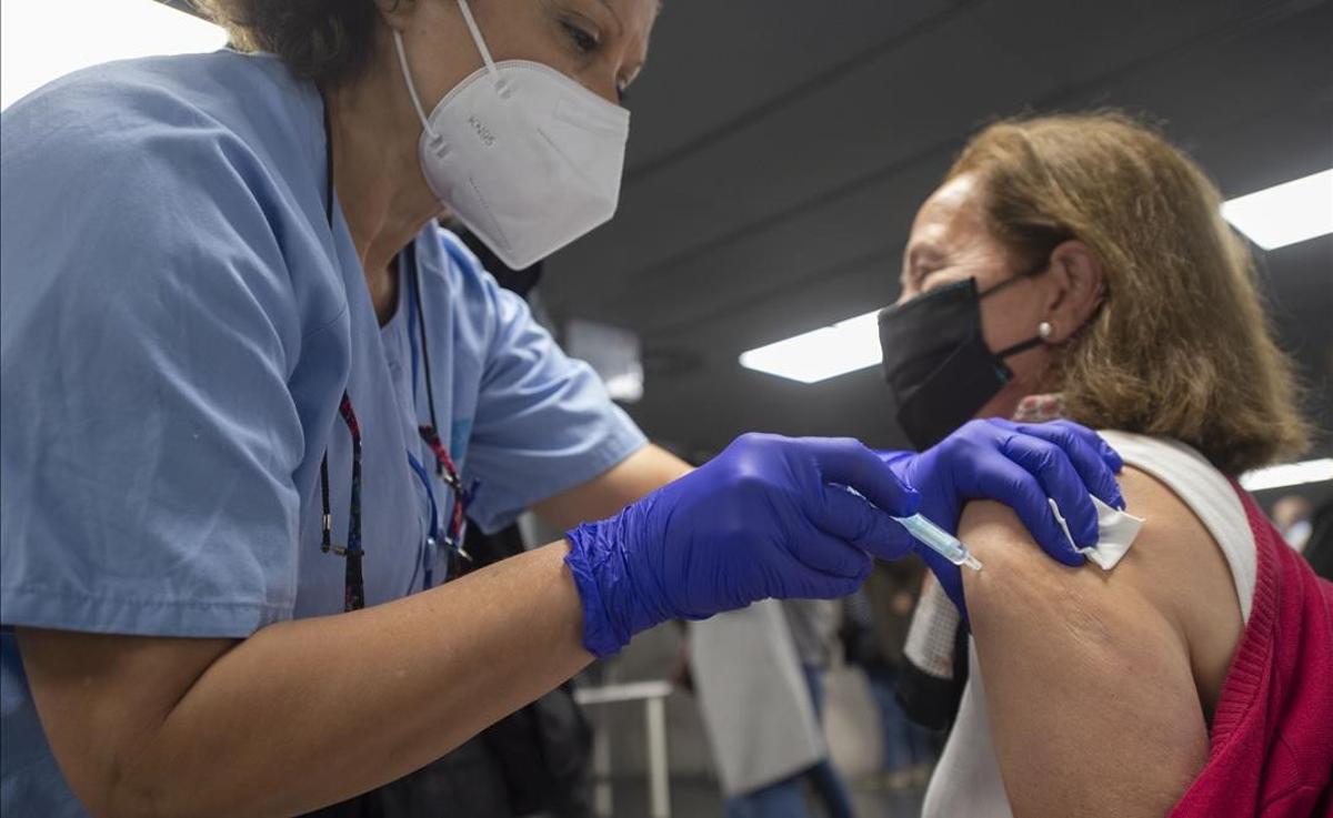 Una trabajadora sanitaria administra la primera dosis de la vacuna AstraZeneca contra el Covid-19 a una persona en el Wizink Center de Madrid.