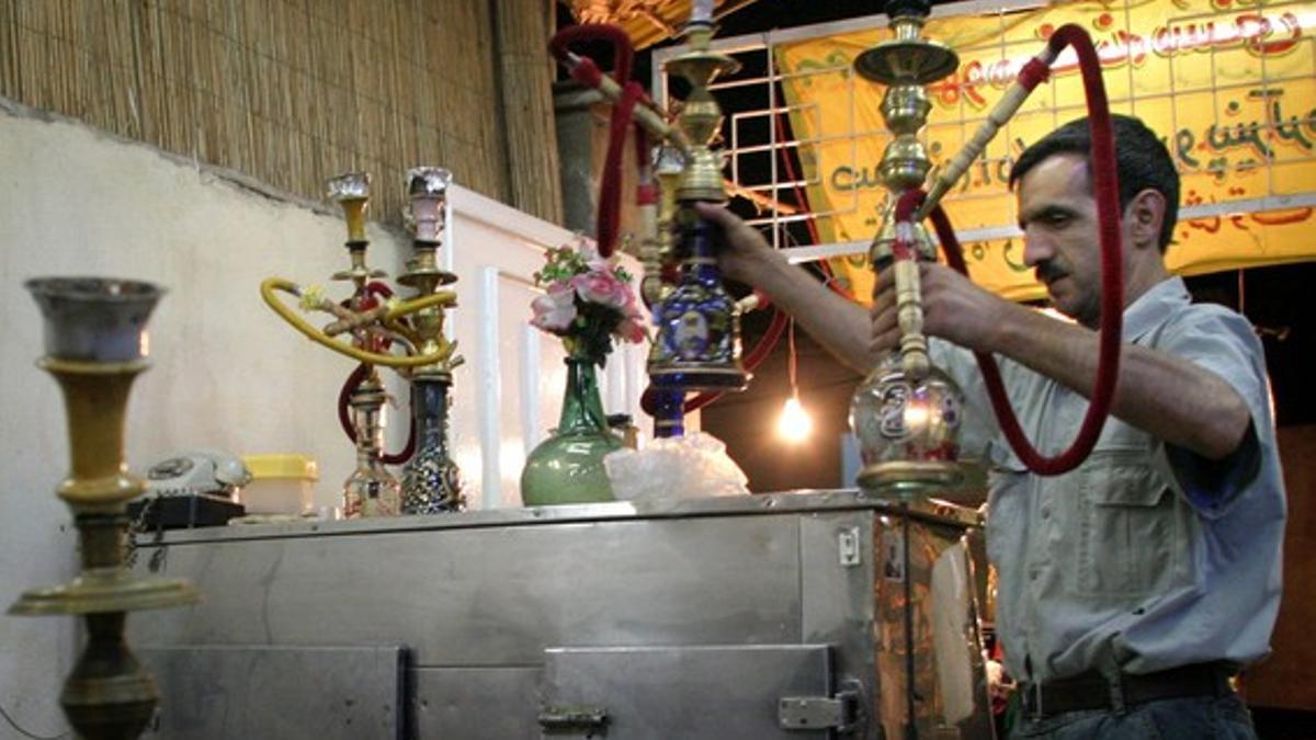 AN IRANIAN RESTAURANTEUR IN TEHRAN PACKS UP HIS WATER PIPES