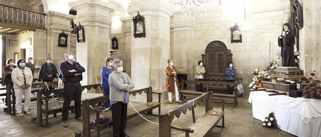 Santa Rita de Cereixo recibió rezos de fieles embozados con mascarillas en vez de las muchas flores que le brindan cada año.// Bernabé / J. Lalín