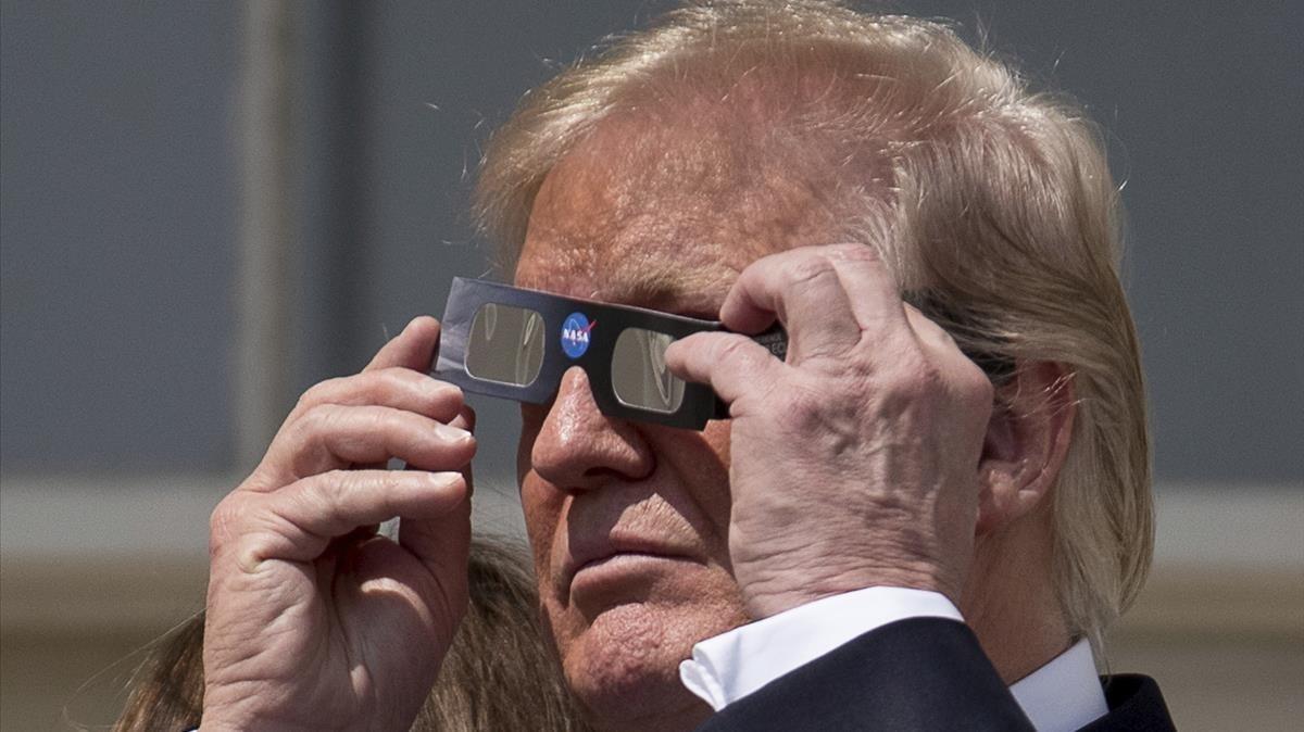 undefined39762445 president donald trump puts on protective glasses to view th170821215104