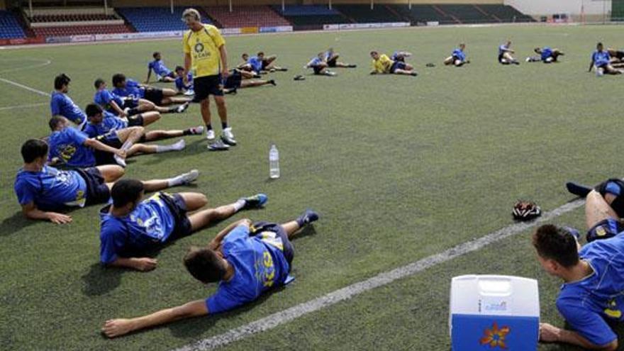 Socorro observa a los jugadores de la UD que realizan estiramientos ayer en la Ciudad Deportiva. i JAVIER FUENTES