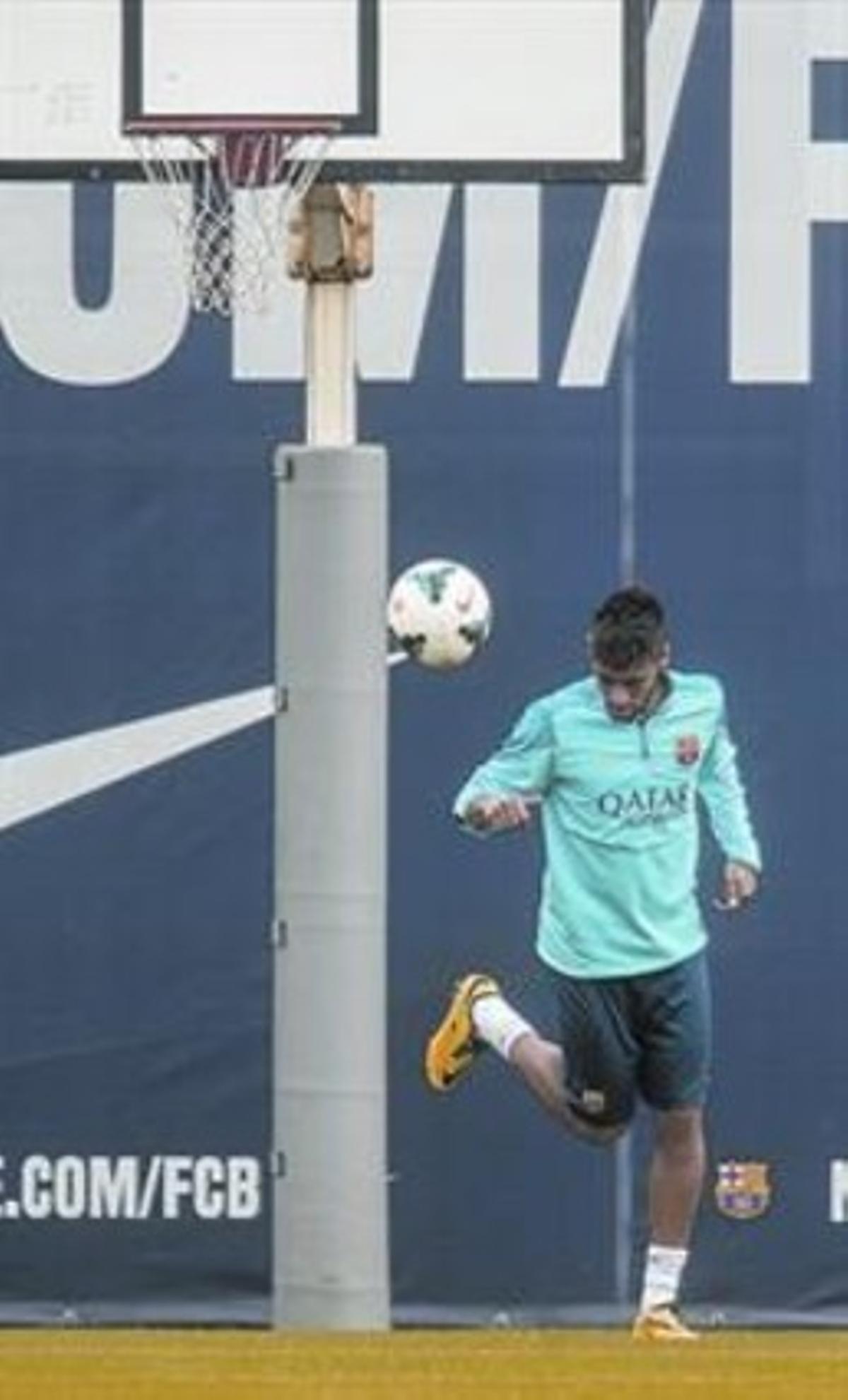 Neymar intenta encistellar una pilota d’esquena al cèrcol en l’entrenament d’ahir.