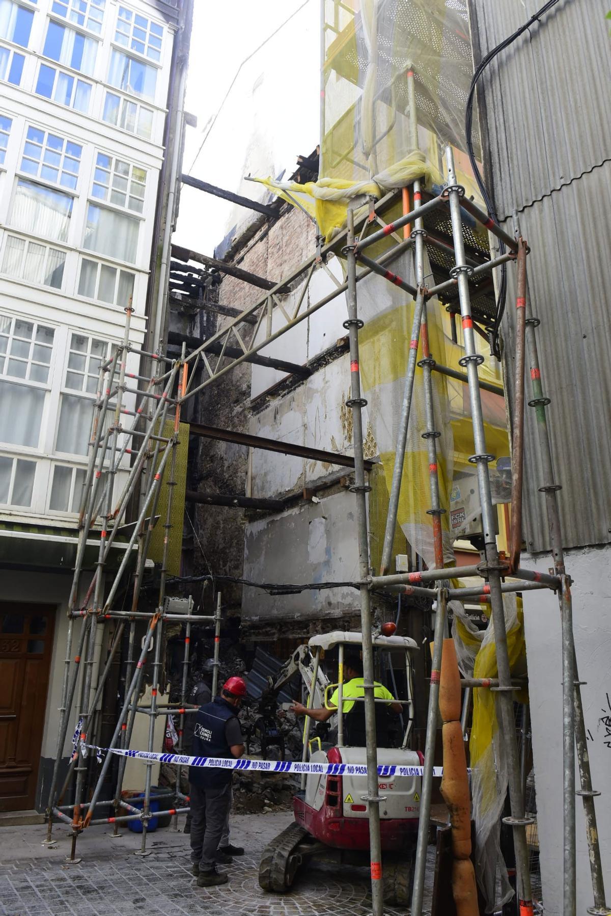 Precinto policial en la zona donde los operarios de la empresa de demolición retiran los restos y escombros.