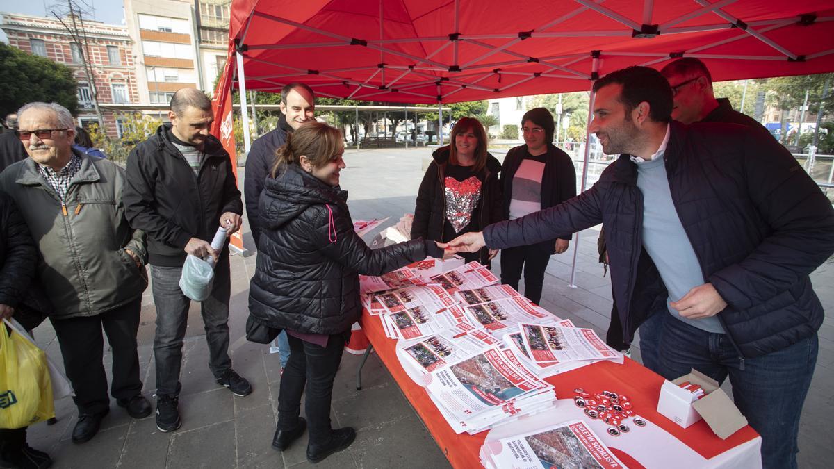 El alcalde y parte de su candidatura, repartiendo la revista del partido.