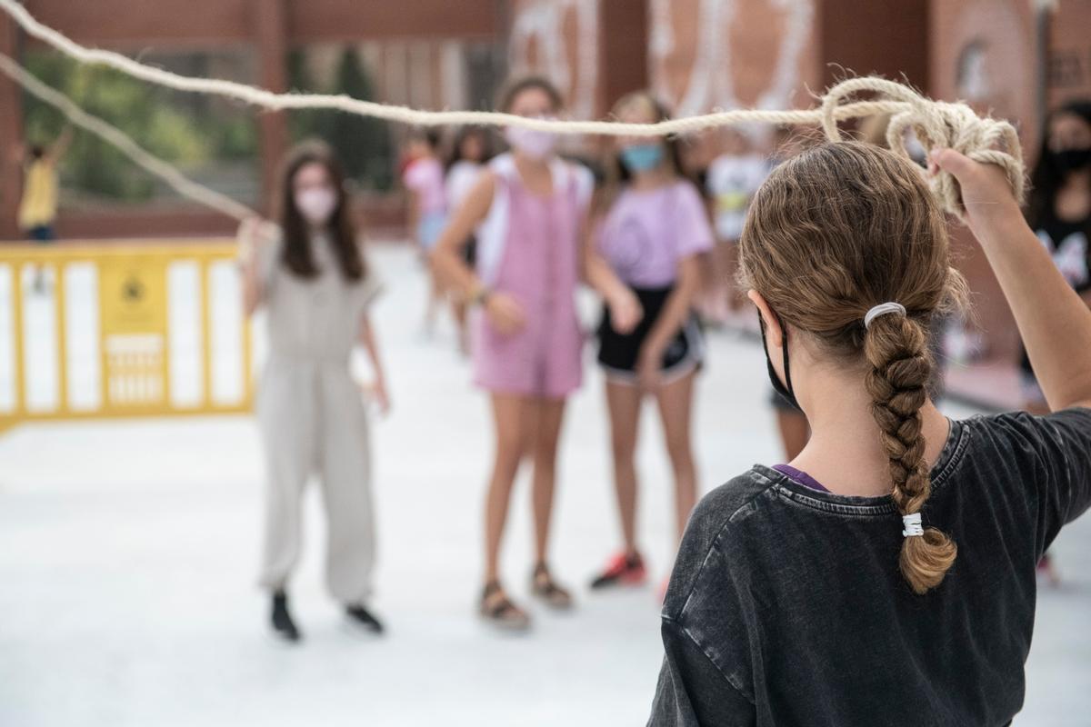 Niños y niñas con mascarilla juegan en el patio de una escuela de Esplugues