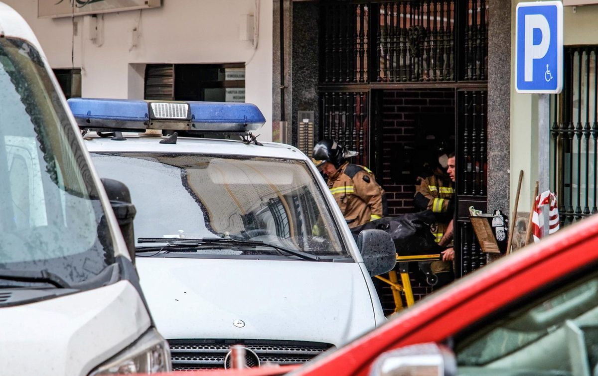 Los bomberos trasladan el cuerpo del fallecido.