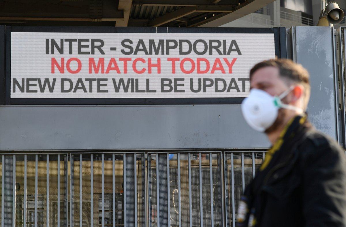 A man wearing a face mask stands outside the San Siro stadium after the Inter Milan v Sampdoria Serie A match was cancelled due to an outbreak of the coronavirus in Lombardy and Veneto, in Milan, Italy, February 23, 2020.REUTERS/Daniele Mascolo