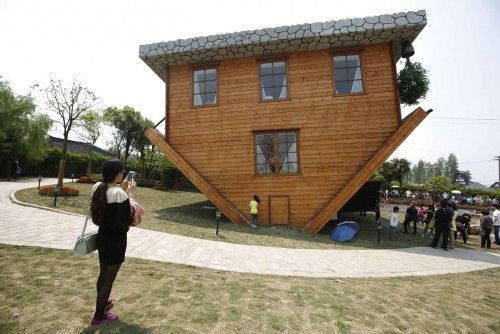 Tourists visit at an upside-down house at Fengjing Ancient Town, Jinshan District, south of Shanghai
