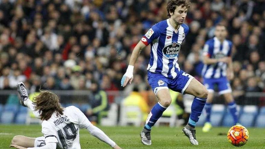 Mosquera controla el balón con Modric en el suelo.