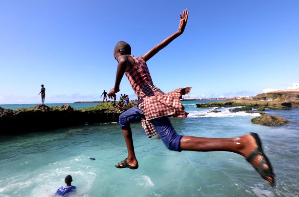 A boy jumps into the Indian Ocean at the ...