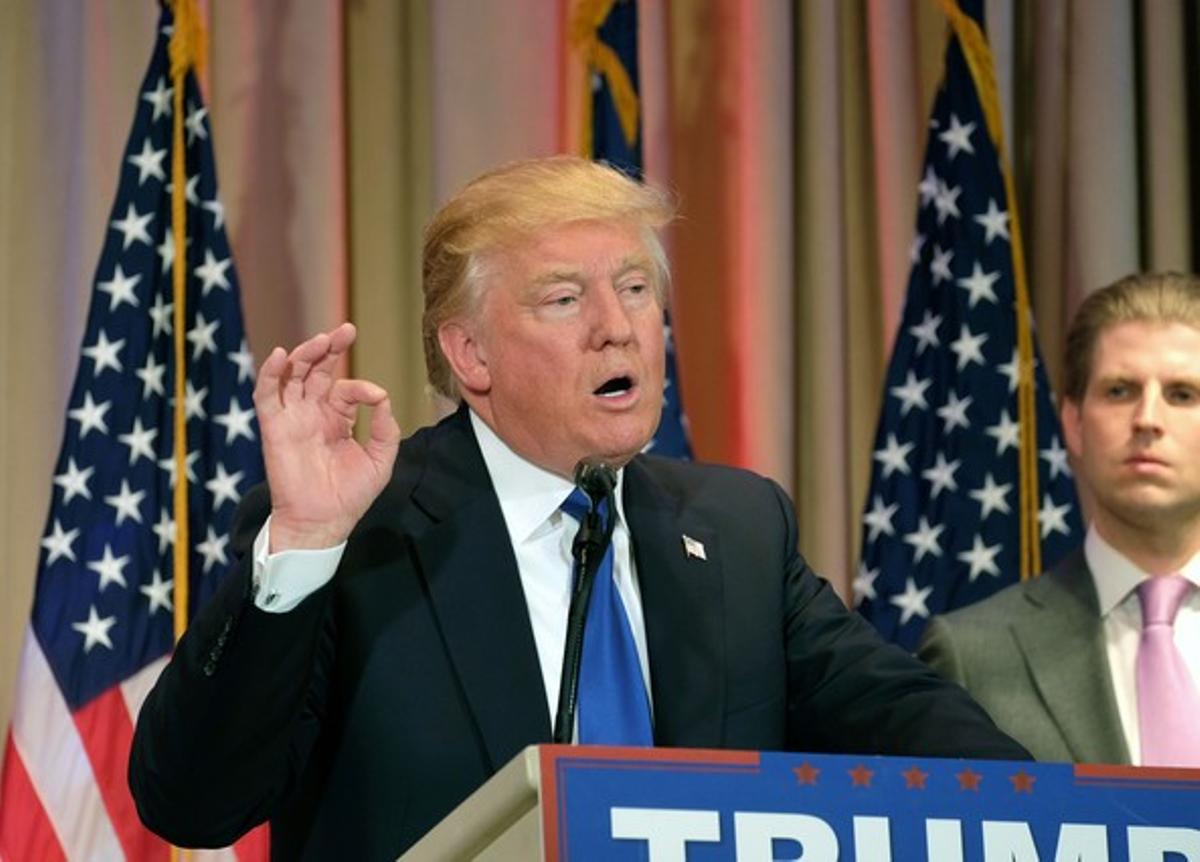 Republican presidential candidate Donald Trump speaks to the media during a campaign event on March 1, 2016 in Palm Beach, Florida, following Super Tuesday poll results. At right is Trump’s son Eric Trump.