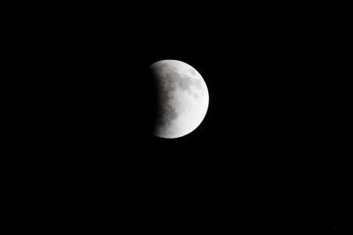 The moon is seen as it begins a total lunar eclipse over Guatemala City