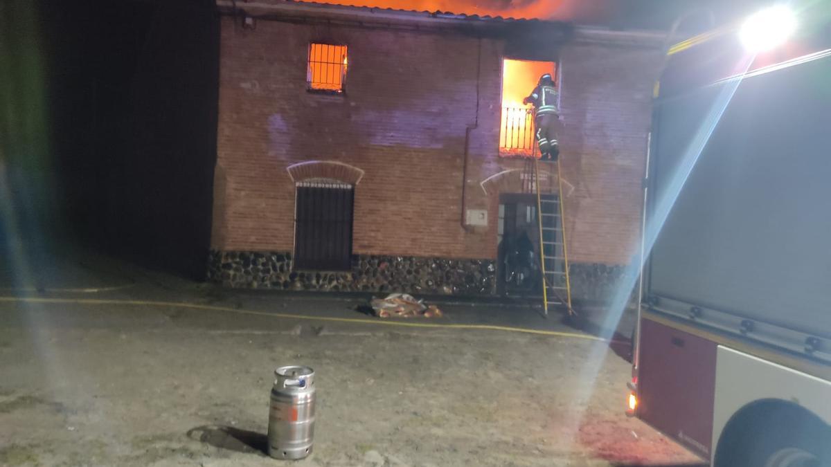 Un bombero trabaja en las labores de extinción del incendio en la vivienda