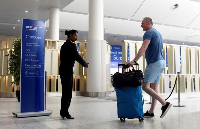 A man arrives at the British Airways check-in ...