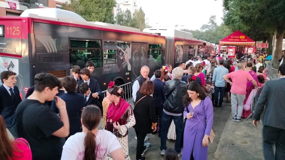 Colas para subirse a un autobús de Tussam en la Feria