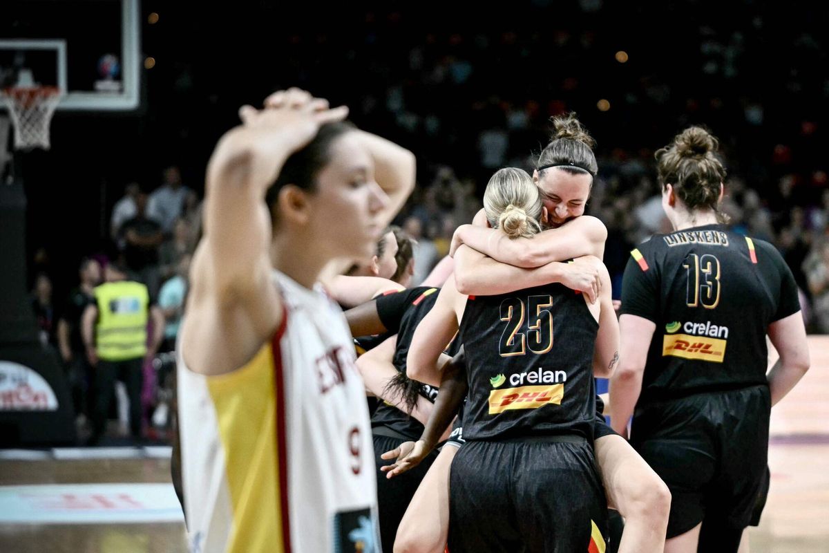 Spain's small forward Helena Pueyo (L) reacts while Belgium team's players celebrate winning the FIBA Women's EuroBasket 2025 final match between Spain and Belgium at the Peace and Friendship Stadium in Athens on June 29, 2025. (Photo by Aris MESSINIS / AFP)