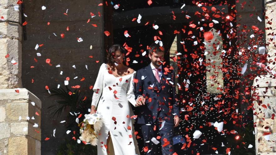 Dos novios salen de la iglesia tras contraer matrimonio.