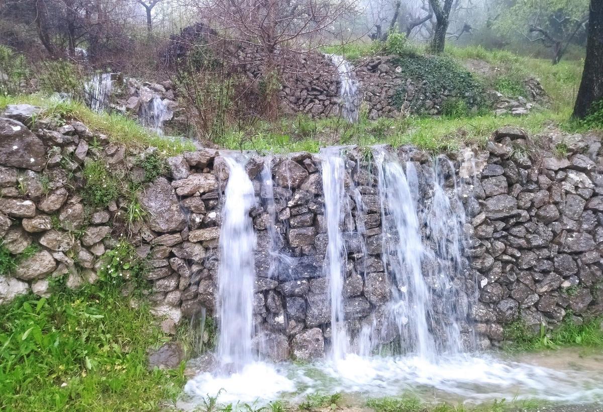 El agua durante las lluvias de Navidad caída incluso de los márgenes de "pedra seca"
