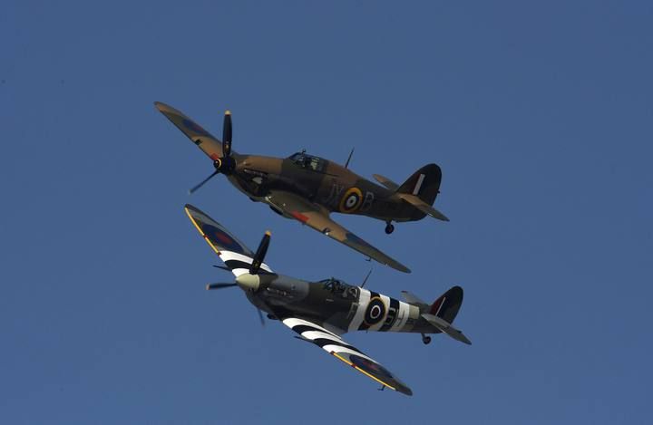 British Hurricane and Spitfire planes perform a fly-past as dozens of 'Little Ships' set sail for Dunkirk in France to mark the 75th anniversary of Operation Dynamo during World War II, from Ramsgate in south east England