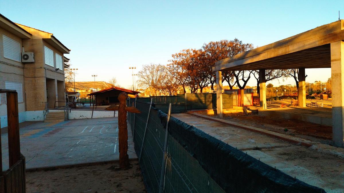 Una valla separa el patio en uso del colegio del trozo que ha quedado dentro de la obra