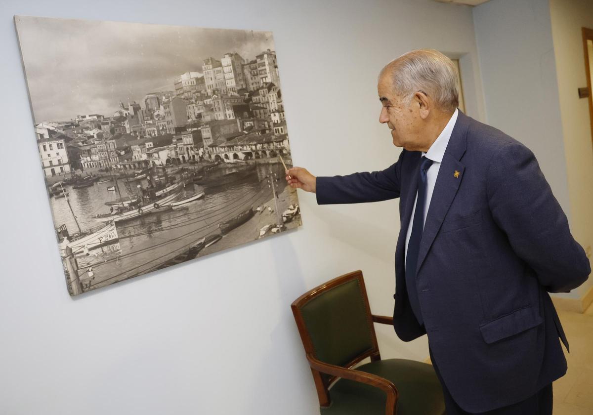 El empresario José García Costas señalando en una fotografía antigua de la Praza do Berbés el lugar donde comenzó a trabajar desde muy joven