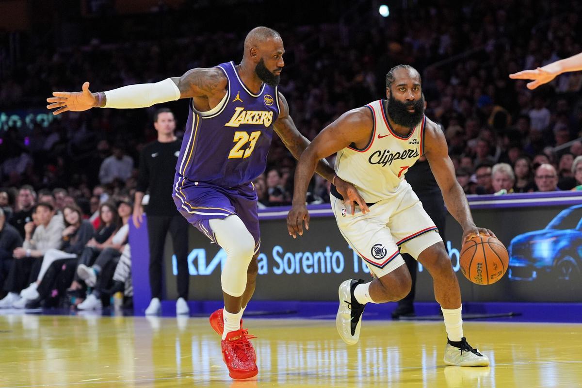 Los Angeles Lakers forward LeBron James (23) pressures Los Angeles Clippers guard James Harden (1) during the second half of an NBA Cup basketball game Tuesday, Nov. 25, 2025, in Los Angeles. (AP Photo/Jae C. Hong)