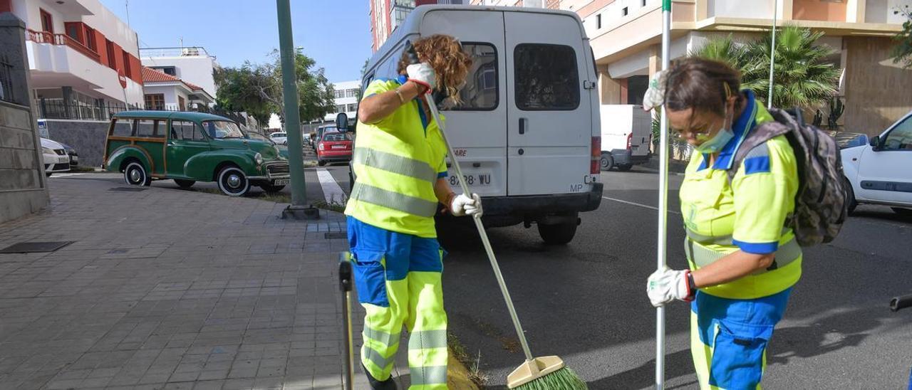 Dos barrenderas limpian una calle en Escaleritas