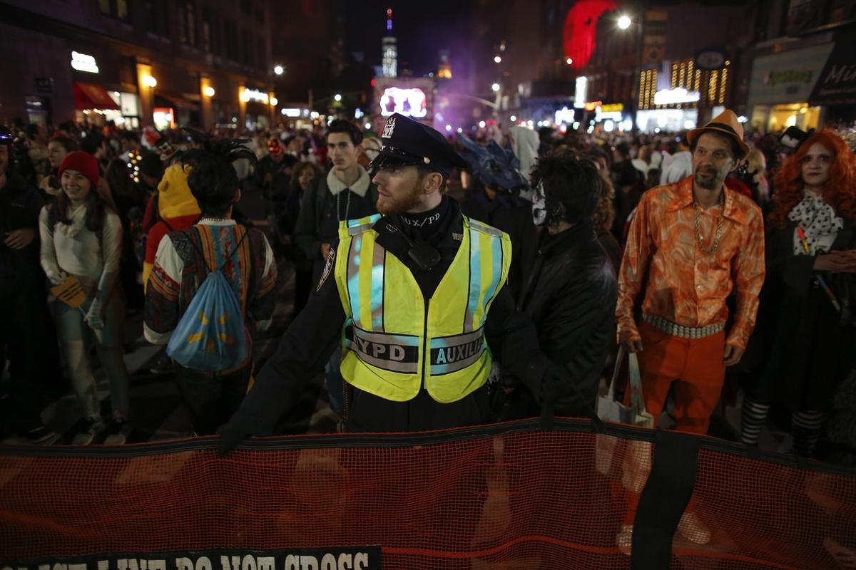 NEW YORK, NY - OCTOBER 31: NYPD officers stand guard during the annual Halloween parade after a man driving a rental truck struck and killed eight people on a jogging and bike path in Lower Manhattan on October 31, 2017 in New York City. Officials are reporting up to 8 dead and at least 15 people have been injured.   Kena Betancur/Getty Images/AFP