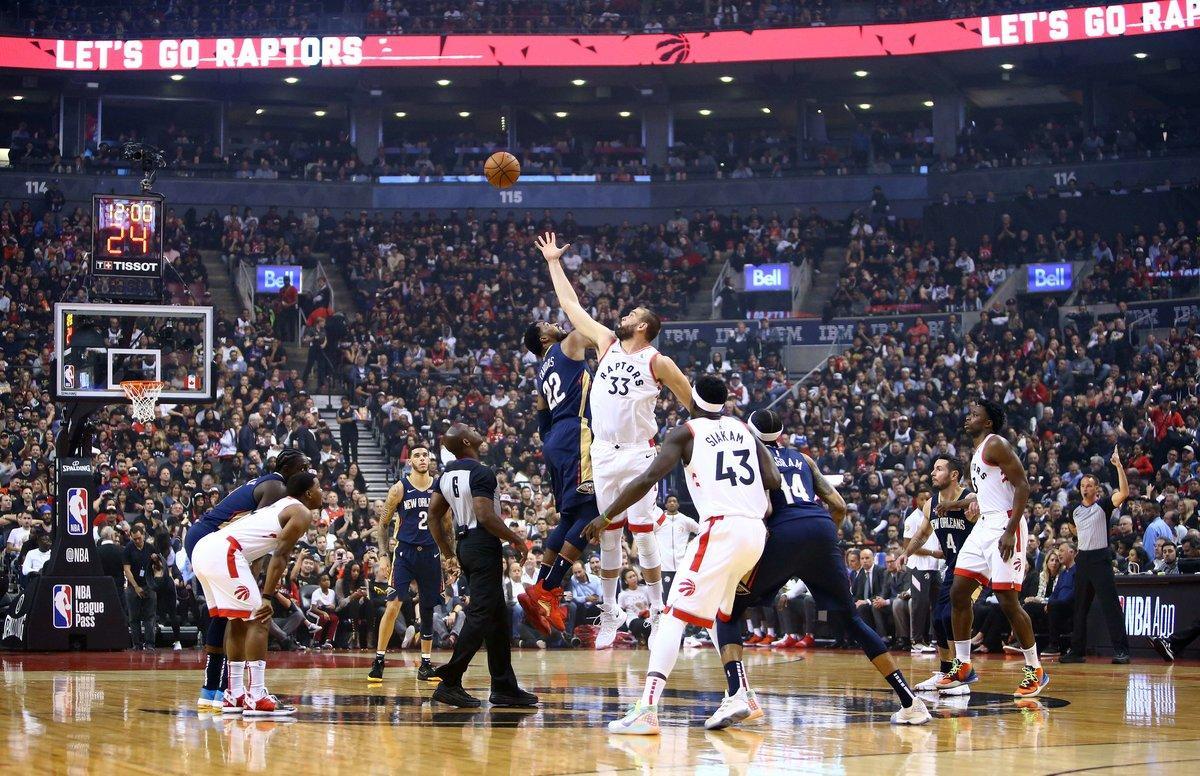 TORONTO, ON - OCTOBER 22: Marc Gasol #33 of the Toronto Raptors contests the opening tip off with Derrick Favors #22 of the New Orleans Pelicans during the first half of an NBA game at Scotiabank Arena on October 22, 2019 in Toronto, Canada. NOTE TO USER: User expressly acknowledges and agrees that, by downloading and or using this photograph, User is consenting to the terms and conditions of the Getty Images License Agreement.   Vaughn Ridley/Getty Images/AFP