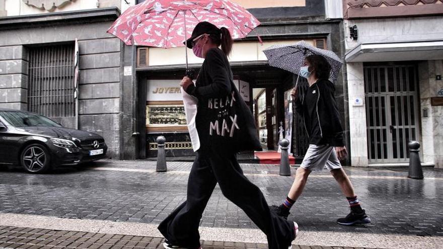 Dos peatones transitan por la calle en la que se ubica la sede del Parlamento de Canarias. | | MARÍA PISACA