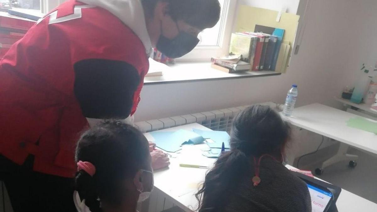 Uno de los voluntarios del programa, con dos niños.