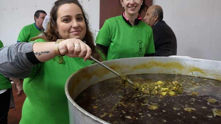 Noemí Martínez y Jessica Álvarez, con el pote que se sirvió en el banquete.