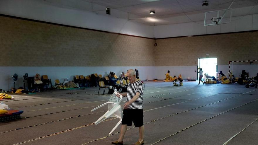 Vecinos de pueblos desalojados por los incendios, en el polideportivo de Villamanta (Madrid)