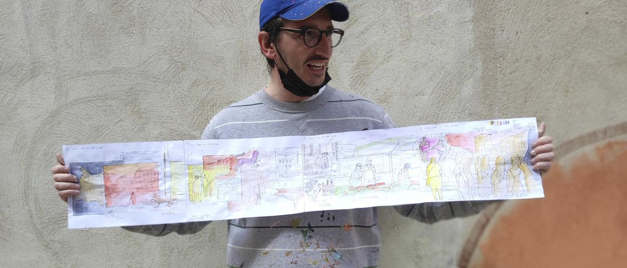 Antonio Feliz, Parsec¡, posando con el boceto del mural que pintó durante cinco días en la calle Ledo del Pozo.