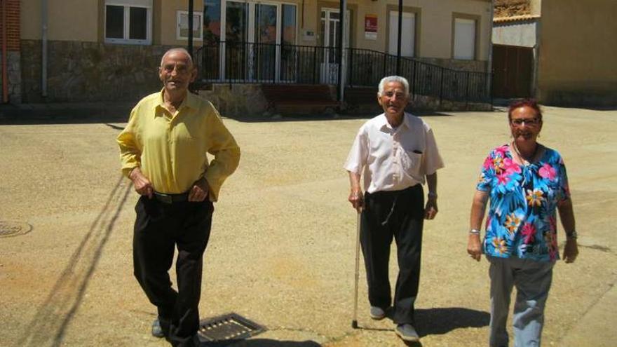 Vecinos de Arrabalde caminan ayer delante del edificio junto al que está previsto construir el velatorio.