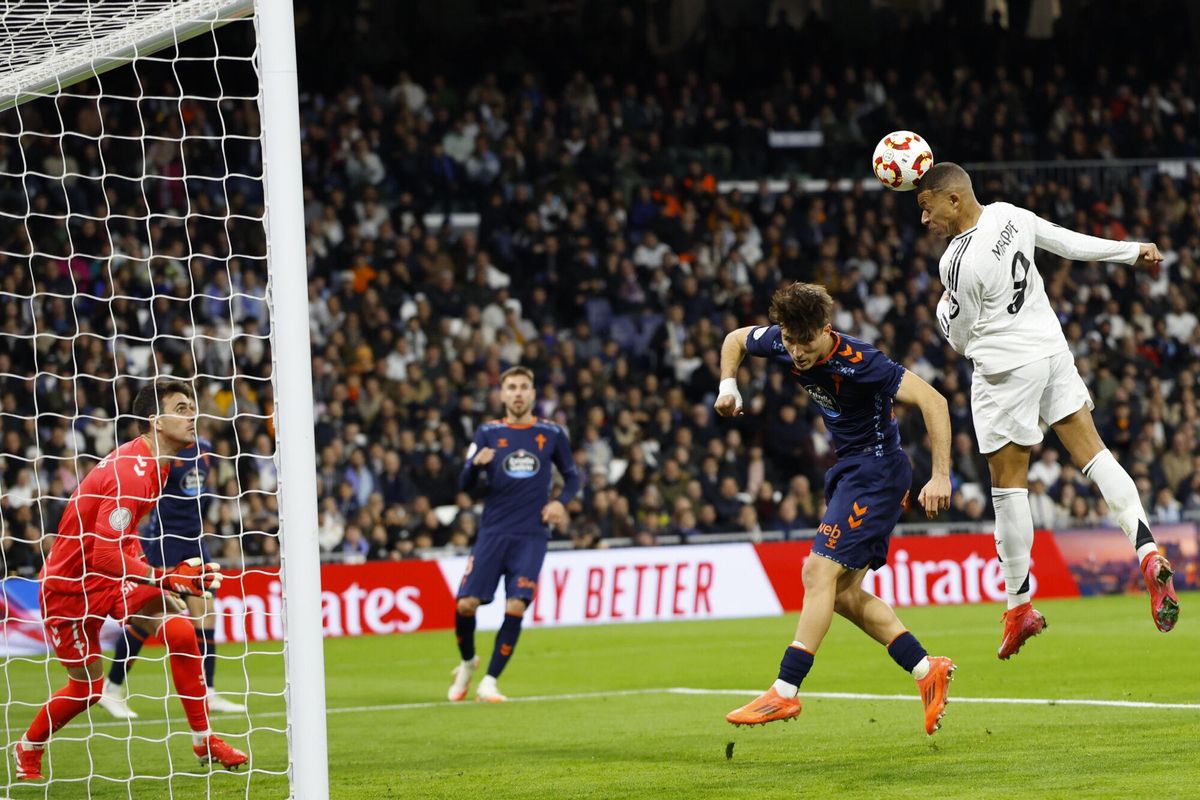 Real Madrids Kylian Mbappe, right, heads a ball next to Celtas Javi Rodriguez during a Copa del Rey round of 16 soccer match at the Santiago Bernabeu stadium in Madrid, Spain, Thursday, Jan. 16, 2025. (AP Photo/Pablo Garcia). EDITORIAL USE ONLY / ONLY ITALY AND SPAIN