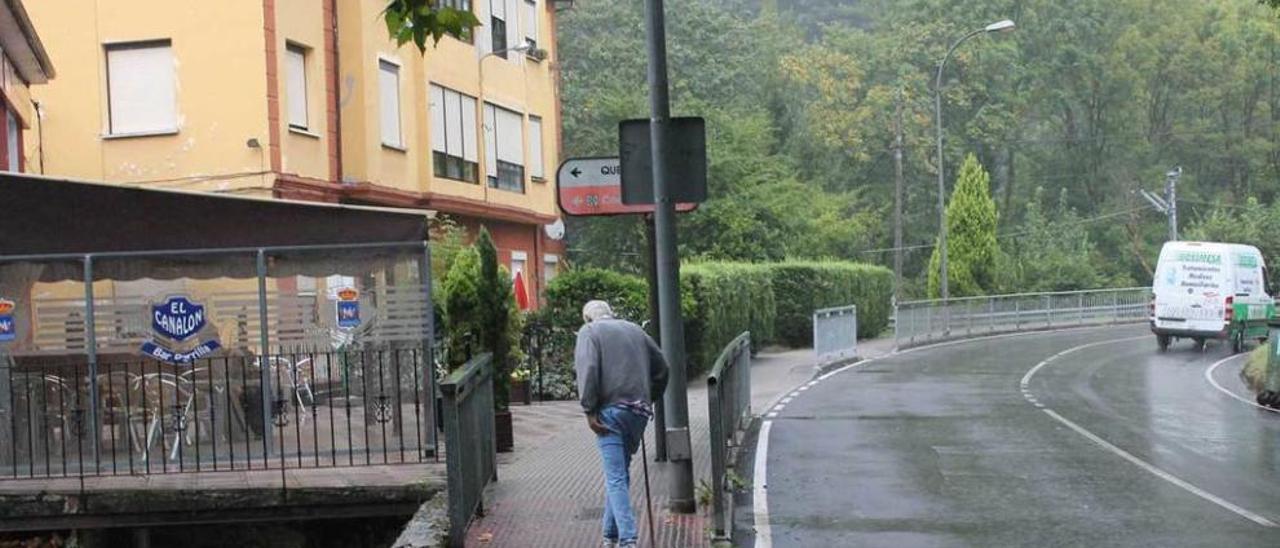 Un peatón camina por la acera en la zona de los accidentes, ayer.