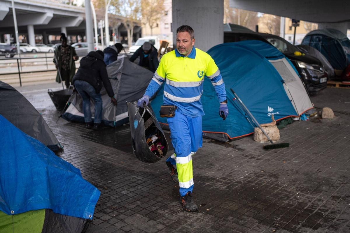 Operarios municipales limpian la zona y retiran las tiendas que han quedado vacías en el asentamiento bajo el puente de la C31