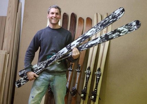 Aichriedler poses with a just finished pair of skis in his "Skiwerk" carpenter's workshop in Mondsee
