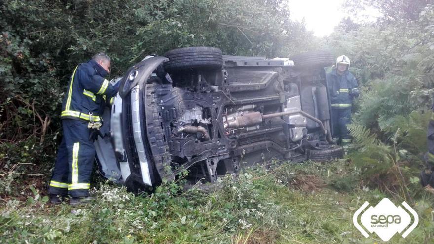 Los efectivos de Bomberos con el coche siniestrado