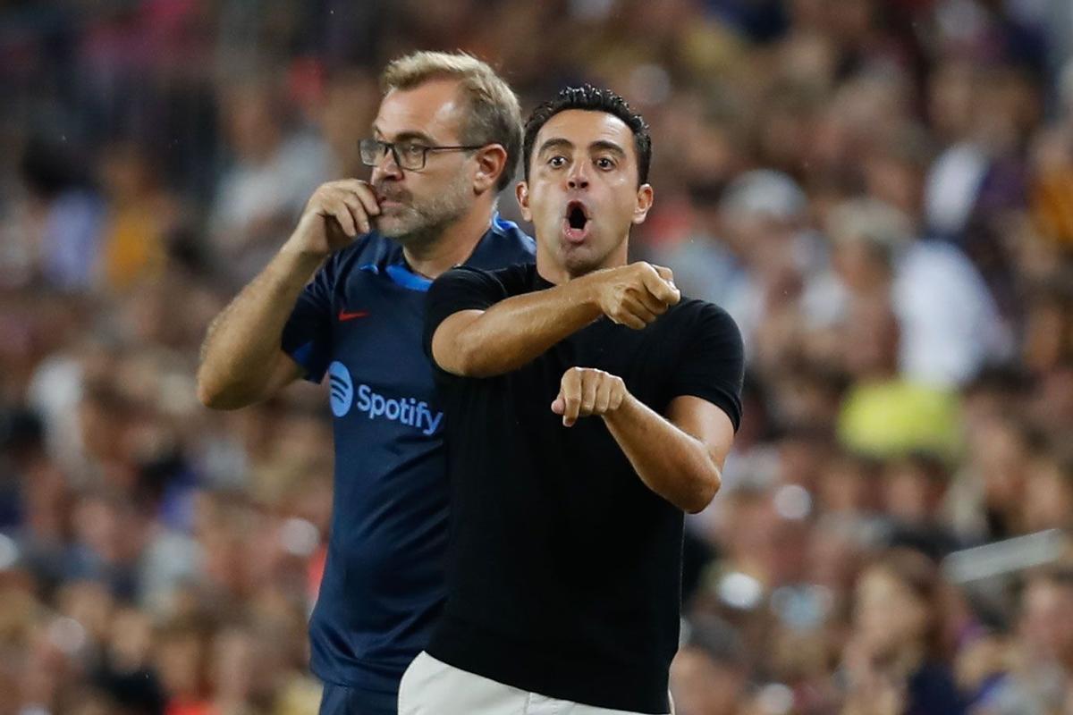 BARCELONA, 13/08/2022.- El entrenador del FC Barcelona, Xavi Hernández (d), junto a su segundo, su hermano Óscar Hernández (i), da instrucciones a sus jugadores durante el partido correspondiente a la primera jornada de LaLiga que FC Barcelona y Rayo Vallecano disputan hoy sábado en el Camp Nou, en Barcelona. EFE/Andreu Dalmau