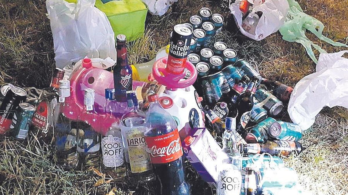 Unas botellas y latas de un botellón.
