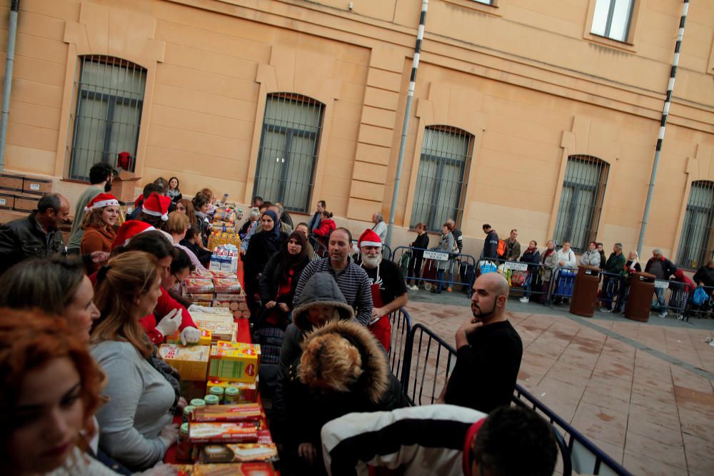 People receive food during a daily food ...