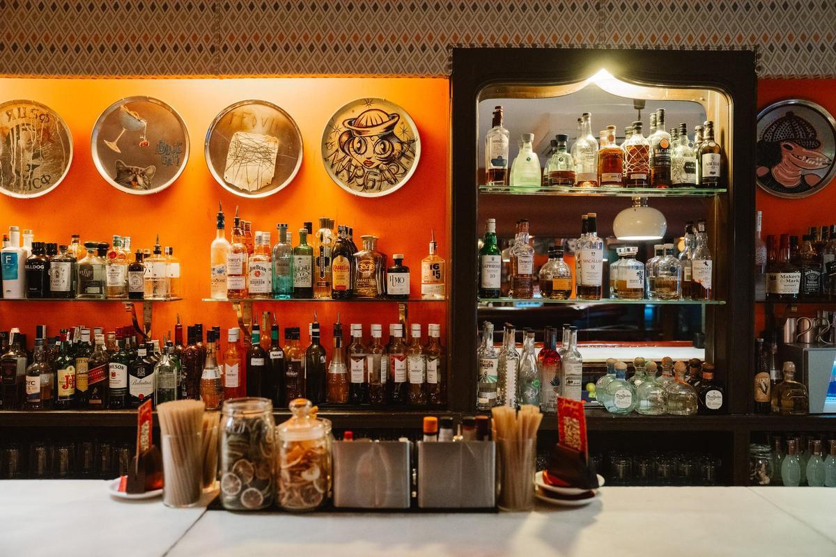 La barra de Josealfredo. Colgadas de la pared, las bandejas que en su día hicieron para el bar artistas como Nacho Mastretta o Víctor Coyote.