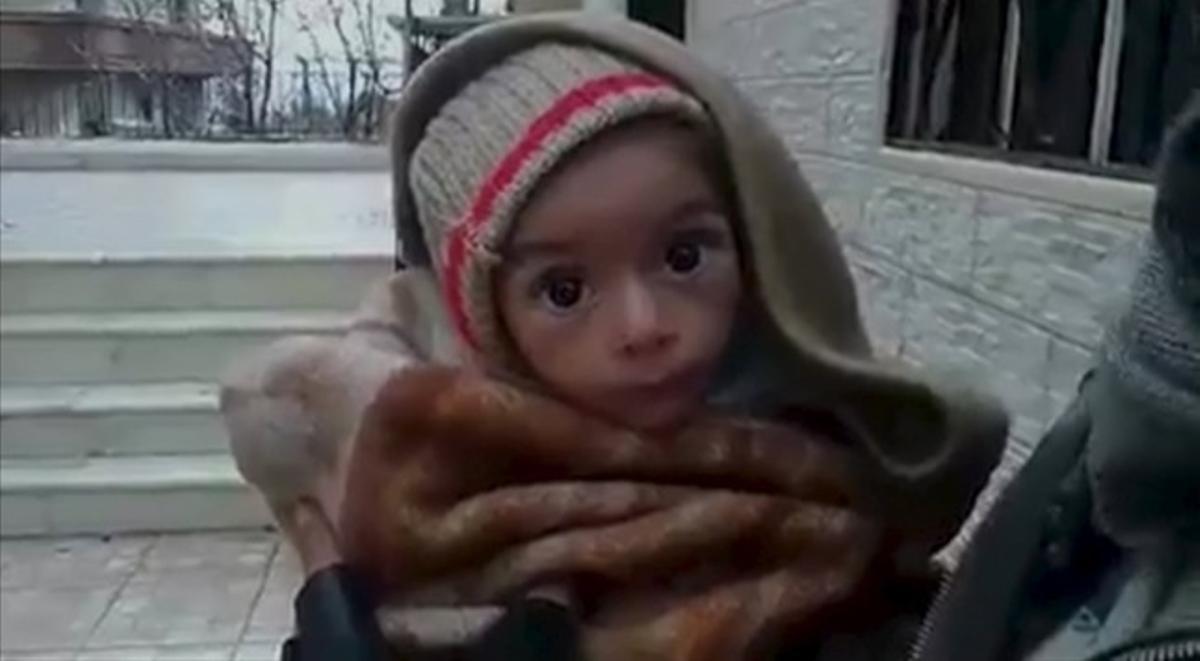 A toddler is held up to the camera in this still image taken from video said to be shot in Madaya on January 5, 2016. Warnings of widespread starvation are growing as pro-government forces besiege an opposition-held town in Syria and winter bites, darkening the already bleak outlook for peace talks the United Nations hopes to convene this month. To match MIDEAST-CRISIS/SYRIA-TOWN  Handout via Social Media Website      ATTENTION EDITORS - THIS PICTURE WAS PROVIDED BY A THIRD PARTY. REUTERS IS UNABLE TO INDEPENDENTLY VERIFY THE AUTHENTICITY, CONTENT, LOCATION OR DATE OF THIS IMAGE. FOR EDITORIAL USE ONLY. NOT FOR SALE FOR MARKETING OR ADVERTISING CAMPAIGNS. THIS PICTURE IS DISTRIBUTED EXACTLY AS RECEIVED BY REUTERS, AS A SERVICE TO CLIENTS. EDITORIAL USE ONLY. NO RESALES. NO ARCHIVE.