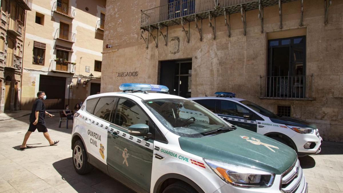 Dos coches de la Guardia Civil aparcados frente a los juzgados de Xàtiva.  | PERALES IBORRA