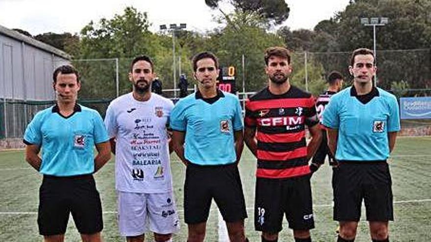 Los capitanes de ambos equipos posan con el trío arbitral antes de iniciarse el partido.